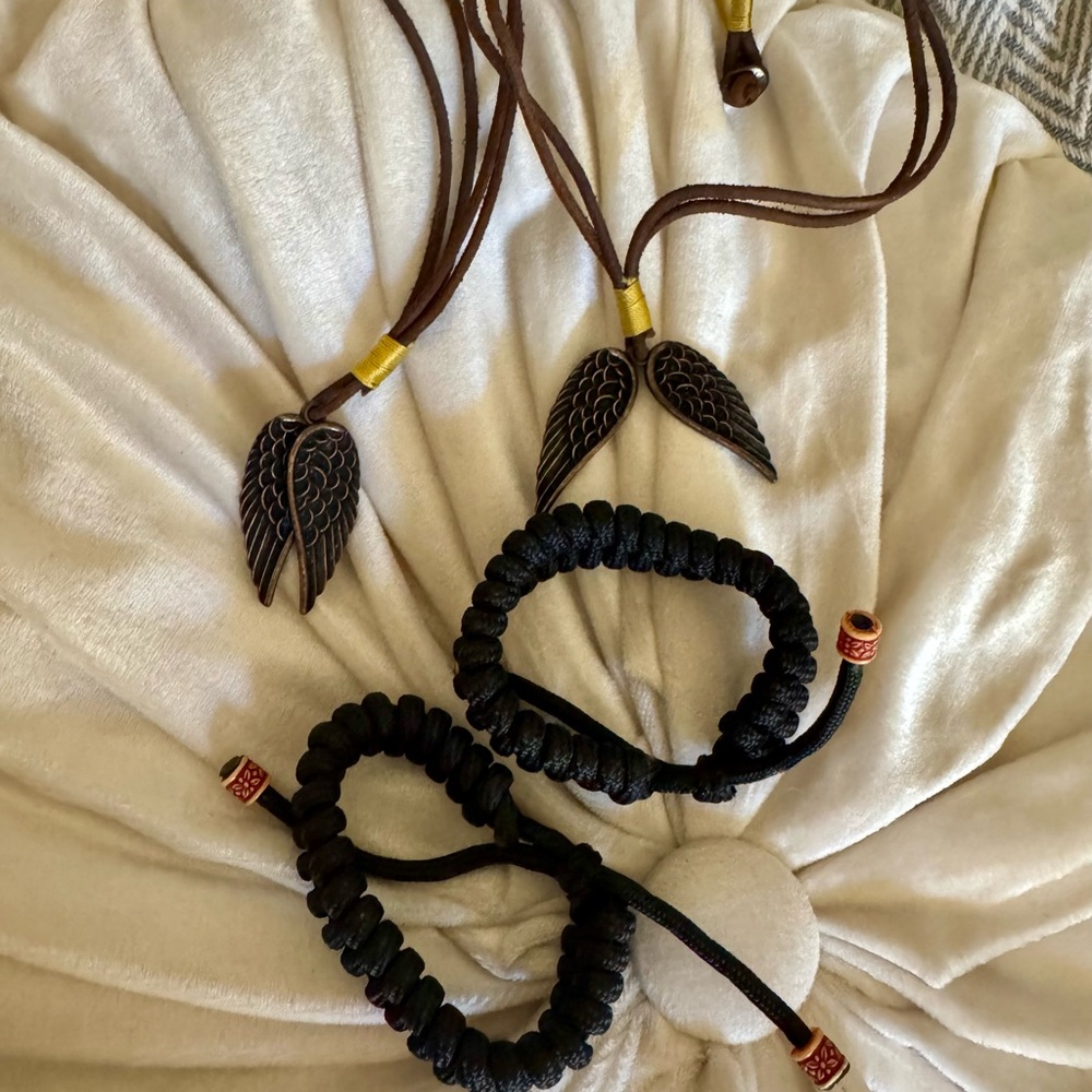 Two sets of leather Necklace with Wing pendant and 2 handmade bracelets .